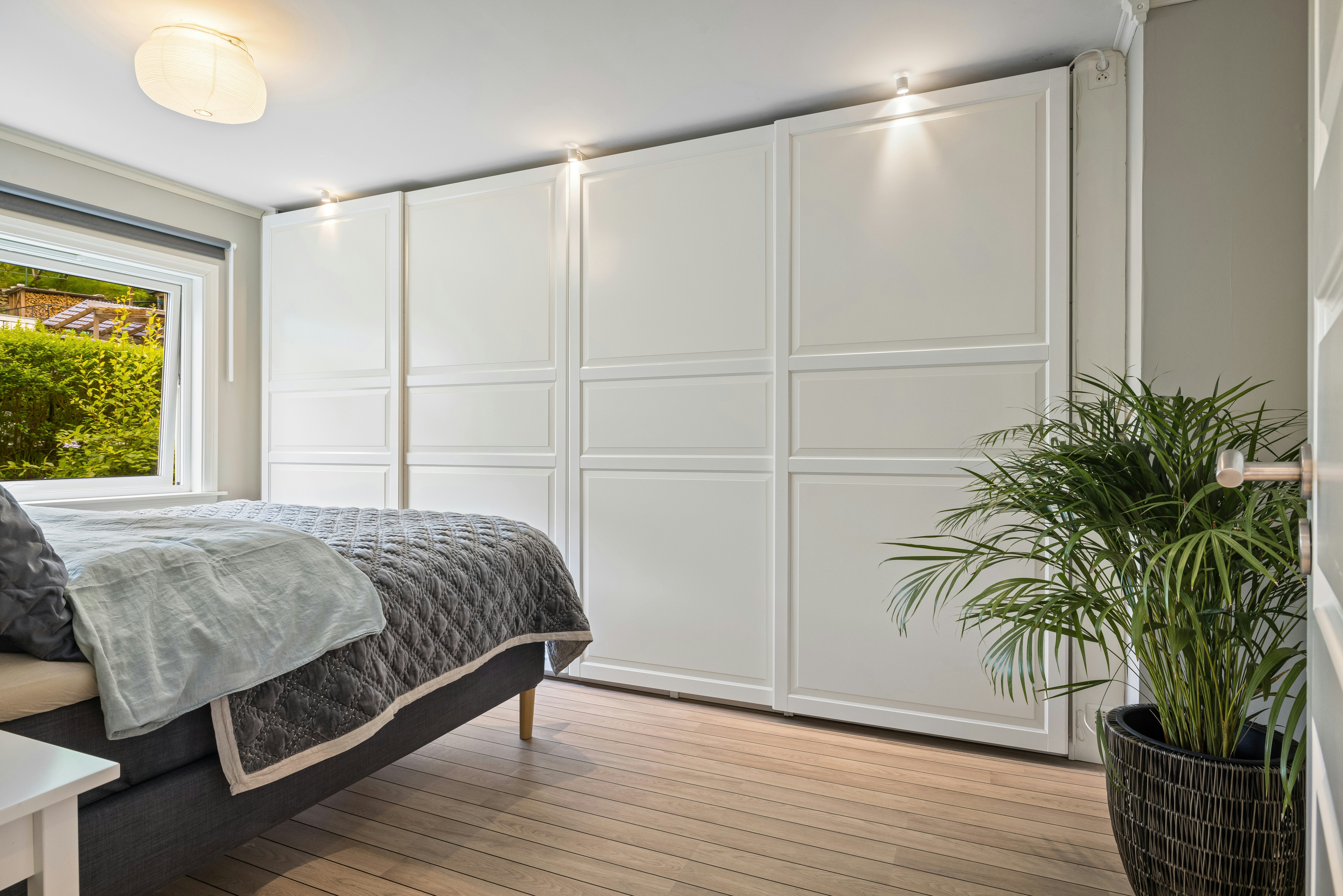 A bedroom with a large bed and a large window